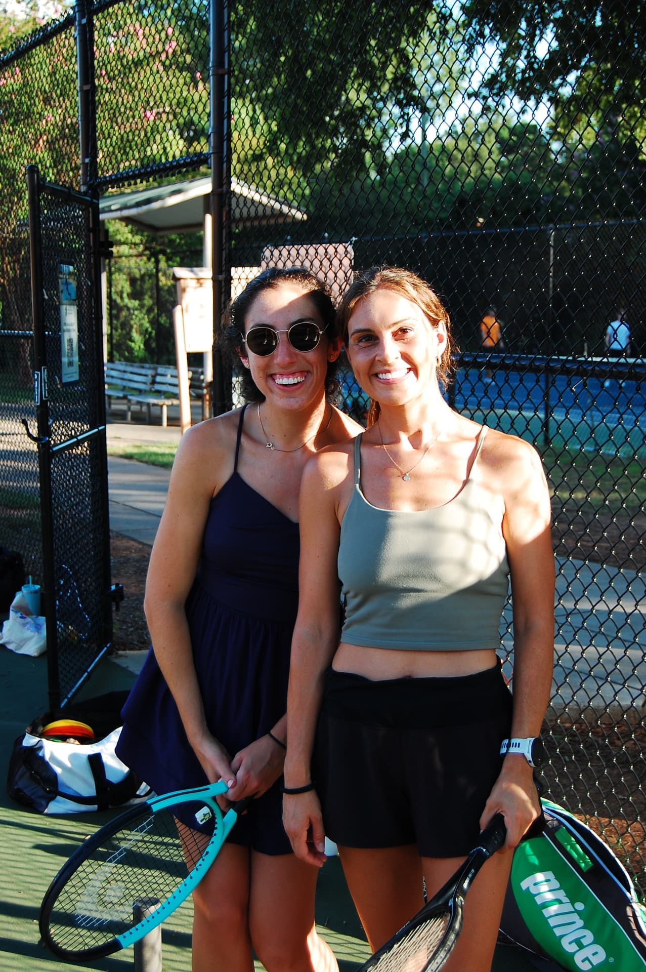 Two Tardeo players smiling with rackets after playing