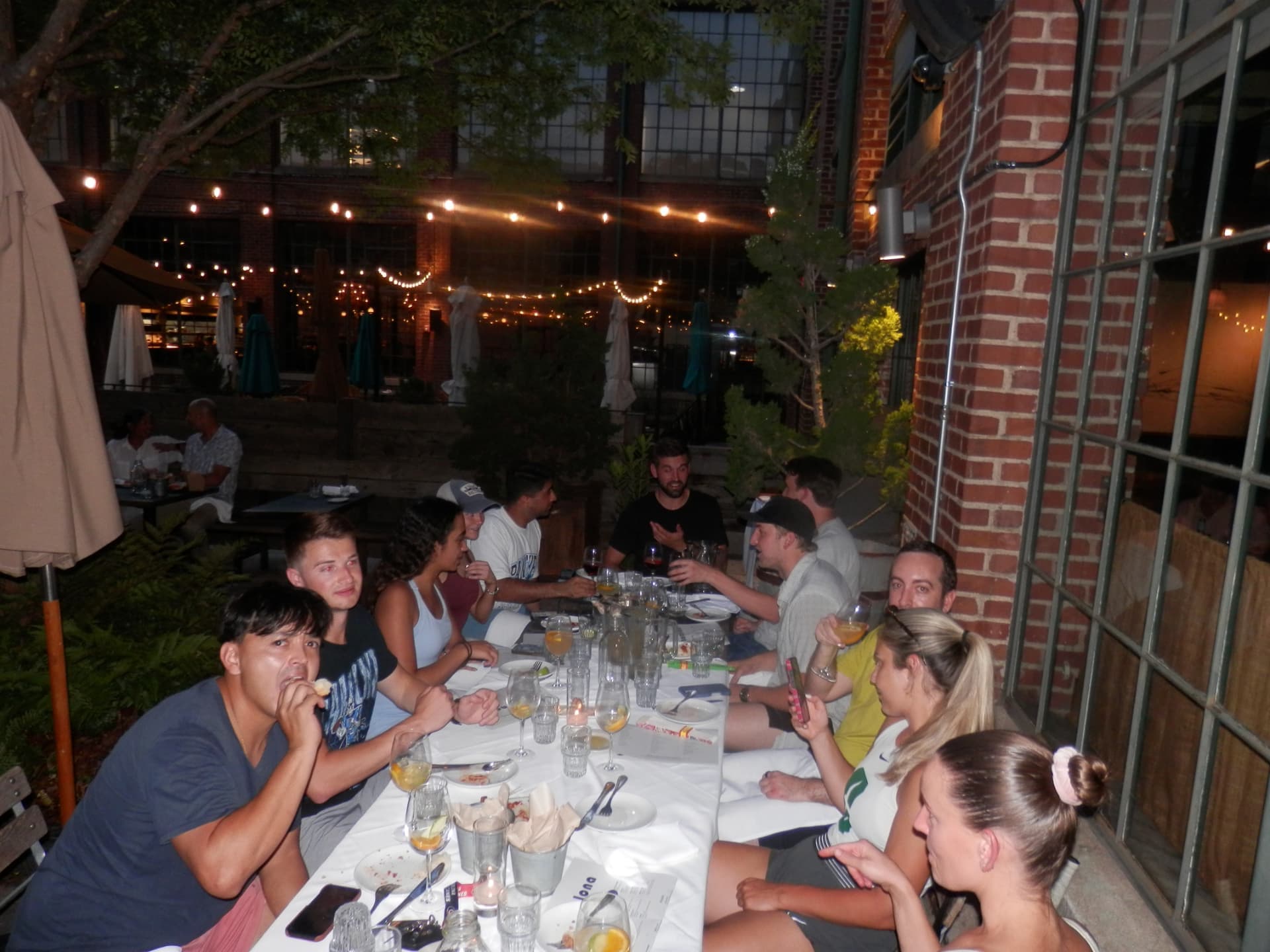 The Tardeo table under string lights after tennis